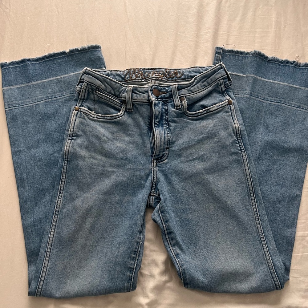 Wrangler women’s jeans have been worn a have a little tear at the bottom
